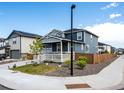 Two-story home featuring a covered porch, well-kept landscaping, and a charming, fenced yard at 3722 Sandy Vista Trl, Castle Rock, CO 80104