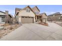 Well-maintained two-story house showcasing three-car garage and tidy landscaping under blue skies at 9742 Taylor River Cir, Littleton, CO 80125