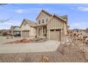 Charming two-story home featuring a three-car garage, with attractive landscaping in front at 9742 Taylor River Cir, Littleton, CO 80125