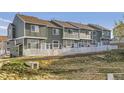 Row of townhomes with fenced yards and pleasant landscaping at 8199 Welby Rd # 3102, Denver, CO 80229