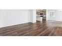 Open-concept living area features hardwood floors, and seamless flow to the kitchen at 690 N Shawnee St, Aurora, CO 80018