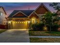 Charming exterior view of a two-story home featuring a stone and siding facade, well-maintained landscaping and driveway at 10221 Nucla St, Commerce City, CO 80022