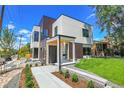 Modern two-story home with a sleek design, manicured lawn, and inviting entrance, perfect for contemporary living at 1491 S York St, Denver, CO 80210