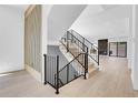 Bright open floor plan with modern staircase and black iron railings leading to the upper level at 1491 S York St, Denver, CO 80210