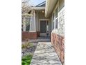 A pathway leads up to the front door with brick accents and decorative columns at 20550 E Lake Cir, Centennial, CO 80016
