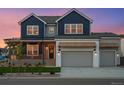 Charming home with a two-car garage and inviting front porch, featuring a wreath on the front door at 1426 Swan Peter Dr, Berthoud, CO 80513