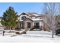 Two-story house with stone accents and a landscaped yard at 24237 E Glasgow Cir, Aurora, CO 80016