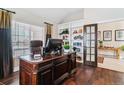 Spacious home office with built-in shelving and hardwood floors at 24237 E Glasgow Cir, Aurora, CO 80016