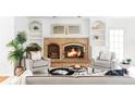Inviting living room featuring a brick fireplace and comfortable seating at 2209 Green Oaks Ln, Greenwood Village, CO 80121