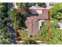 Aerial view of the home showcasing the backyard patio, mature trees, and driveway at 801 S Steele St, Denver, CO 80209