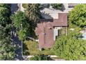Aerial view of the home showcasing the backyard patio, mature trees, and driveway at 801 S Steele St, Denver, CO 80209