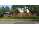 Exterior side view of home with a wooden fence, providing privacy and security at 801 S Steele St, Denver, CO 80209