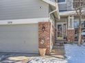 Front entrance with brick walkway, and a two car garage at 2676 S Troy Ct, Aurora, CO 80014