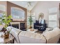 Spacious living room featuring a fireplace and large windows at 2676 S Troy Ct, Aurora, CO 80014