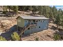 Two-story home with multi-level decks and landscaping at 27341 Ridge Trl, Conifer, CO 80433