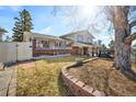 This backyard has a patio and green grass perfect for relaxation and outdoor enjoyment at 1691 S Arbutus Pl, Lakewood, CO 80228