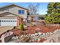 This two-story home is beautifully landscaped with brick accents and a cozy front porch area at 1691 S Arbutus Pl, Lakewood, CO 80228