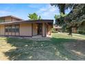 Inviting single-story house with well-maintained lawn and mature trees at 3720 S Fairplay Way, Aurora, CO 80014