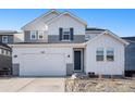 Two-story home with gray and white siding, a two-car garage, and landscaping at 3589 Rucksack Ct, Castle Rock, CO 80108