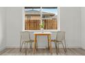 Cozy dining area with a small table, chairs, and a view to the back yard at 3311 Jasmine St, Denver, CO 80207