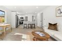 Open-concept living space with a breakfast bar, modern kitchen, and comfortable living area at 3311 Jasmine St, Denver, CO 80207