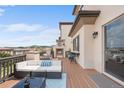 Enjoy rooftop views and a cozy fireplace on this deck with ample seating and outdoor bar at 10468 Ladera Dr, Lone Tree, CO 80124