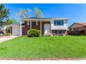 Charming two-story home with a brick facade, manicured lawn, and inviting front porch at 1081 E 119Th Pl, Northglenn, CO 80233