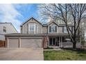 Charming two-story home featuring a covered front porch, brick accents, and a well-manicured lawn at 13340 Saint Paul St, Thornton, CO 80241