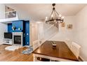 Dining room with a modern chandelier, hardwood floors, and a cozy fireplace at 546 Lost Valley Pt, Castle Rock, CO 80108