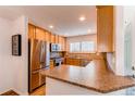 Updated kitchen with stainless steel appliances, granite countertops, and bright natural light and well organized layout at 546 Lost Valley Pt, Castle Rock, CO 80108