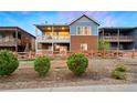 View of back exterior with two-story deck and a wooden fence surrounding the yard at 12575 Sandstone Dr, Broomfield, CO 80021