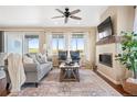 Inviting living room with large windows, a fireplace, and neutral decor for a cozy atmosphere at 12575 Sandstone Dr, Broomfield, CO 80021