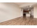 Open-concept living room flows into modern kitchen with stainless steel appliances and island at 9633 E 5Th Ave # 10304, Denver, CO 80230