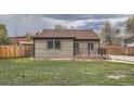 Beautiful backyard with lush green lawn and a wooden fence, perfect for outdoor activities at 6000 Yarrow St, Arvada, CO 80004