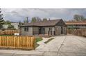 Beautifully updated home with a charming front porch, driveway, and lovely fenced yard at 6000 Yarrow St, Arvada, CO 80004