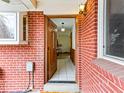 Welcoming brick entryway with an open wooden door and tiled floors at 1050 Youngfield St, Golden, CO 80401