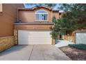 Two-story home featuring a two-car garage, brick accents, and well-maintained landscaping at 163 Ward Ct, Lakewood, CO 80228
