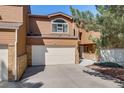 Two-story home for sale featuring a two-car garage, brick accents, and landscaping at 163 Ward Ct, Lakewood, CO 80228
