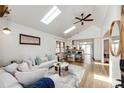 Bright open-concept living room with vaulted ceiling, skylights, and hardwood floors at 2039 S Sherman St, Denver, CO 80210