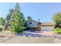 Ranch-style home with brick and siding exterior, featuring a large driveway at 9852 Zephyr Dr, Broomfield, CO 80021