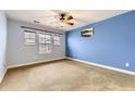 Minimalist bedroom featuring carpeted floors, windows for natural light, and soothing wall colors at 9023 Apache Plume Dr # D, Parker, CO 80134