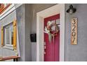 Close-up of the home's entry, highlighted by a colorful door and stylish exterior details at 3207 N Marion St, Denver, CO 80205