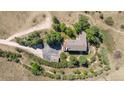 An aerial view of an estate featuring a large home, driveway, mature trees, and surrounding land at 8853 N Awl Rd, Parker, CO 80138