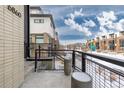 Modern townhome with balcony, snowy landscape at 6860 E Lowry Blvd, Denver, CO 80230