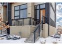 Modern home's exterior with snowy front steps at 6860 E Lowry Blvd, Denver, CO 80230