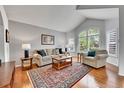 Cozy living room with hardwood floors, vaulted ceilings and plantation shutters for added privacy at 10653 W Parkhill Dr, Littleton, CO 80127
