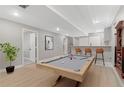 Finished basement featuring a pool table, bar area, and recessed lighting at 12992 W Jewell Cir, Lakewood, CO 80228