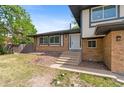 A well-maintained yard leads to the inviting entrance of this home, complemented by neat landscaping at 12992 W Jewell Cir, Lakewood, CO 80228