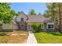 Charming home with stone accents and well-maintained lawn, creating a welcoming curb appeal at 4850 S Kittredge St, Aurora, CO 80015