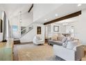 Spacious living room with hardwood floors, a staircase, and an open connection to the dining area at 4850 S Kittredge St, Aurora, CO 80015